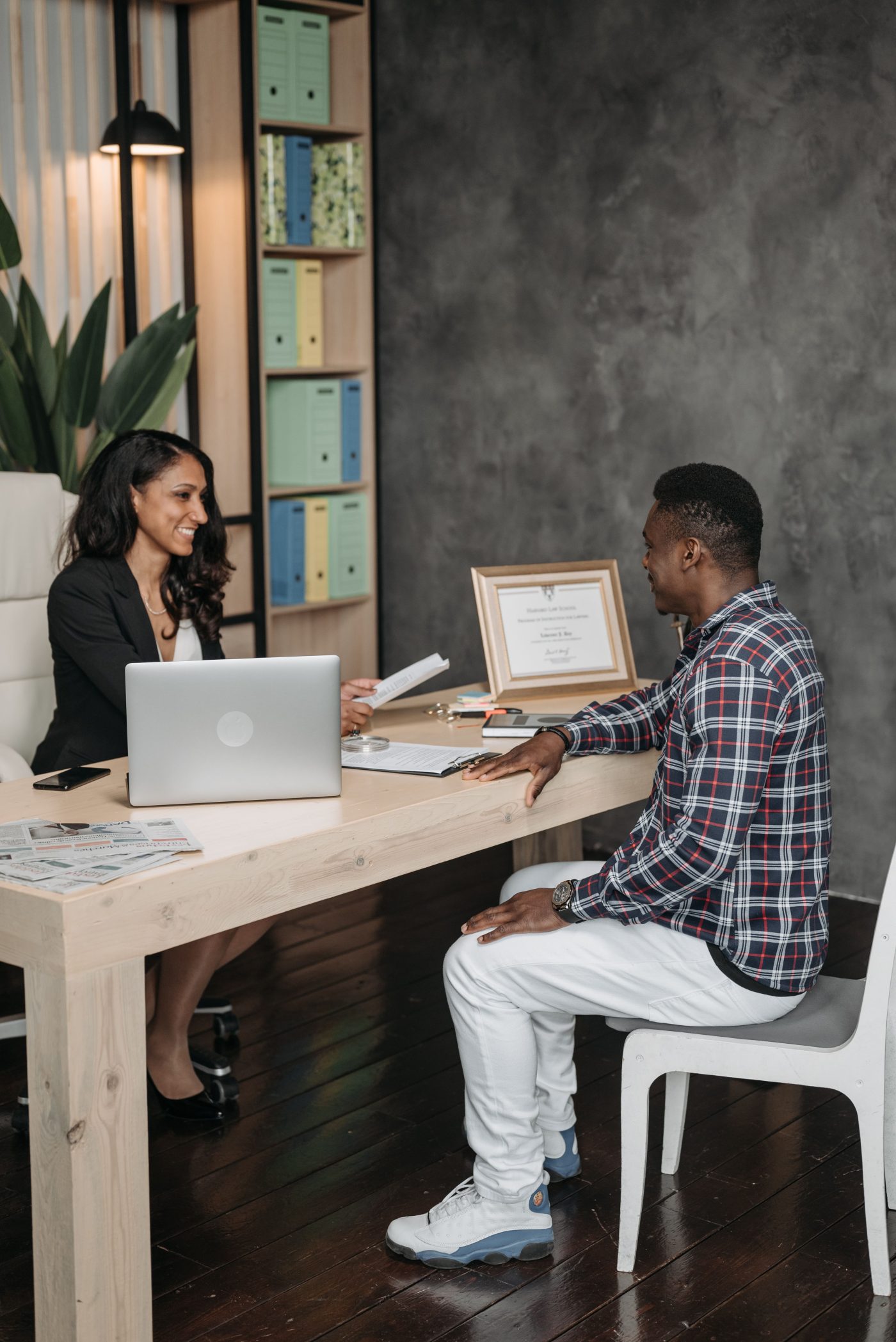 A professional case handler at a desk, speaking with a client